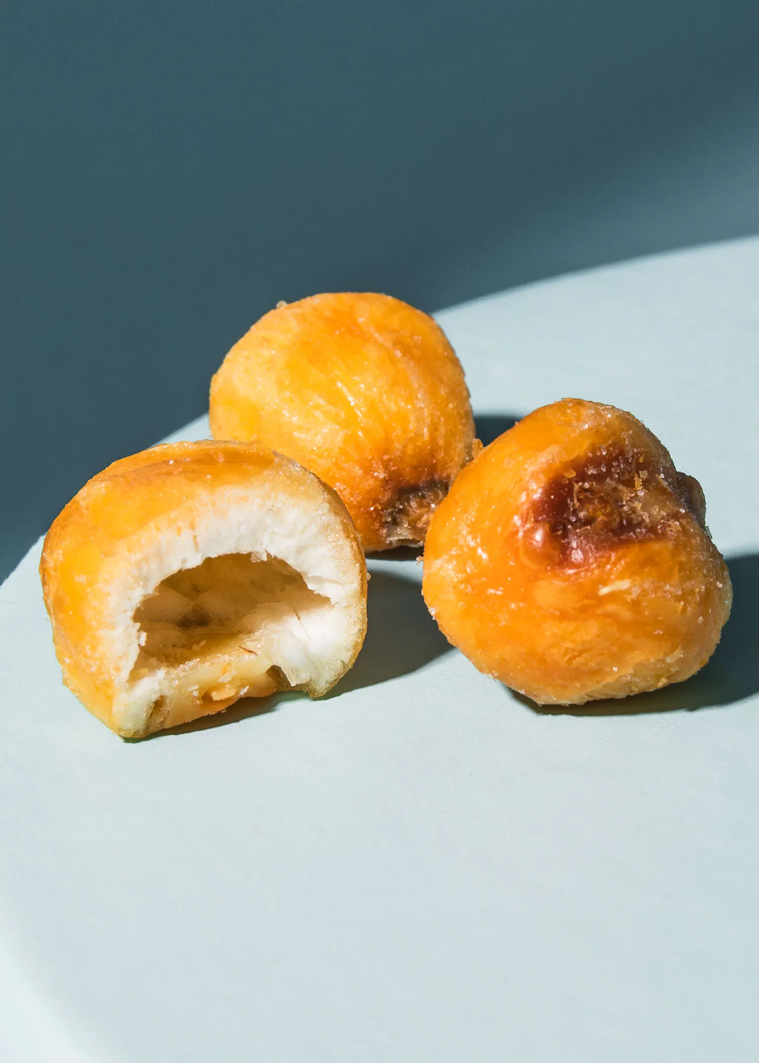 drei Donuts auf einem Teller mit einem Stück genommen